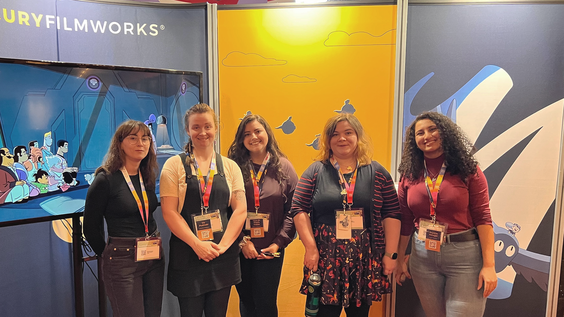 Naomi Devenport, Vic Putinski, Giza Di Giosa, Erica Staples, and Aryana Alnajjar work the Mercury Filmworks booth at OIAF 2022.