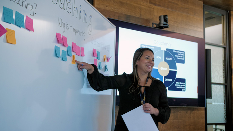 Talent Partner from Mercury Filmworks giving a presentation as she points to a whiteboard.