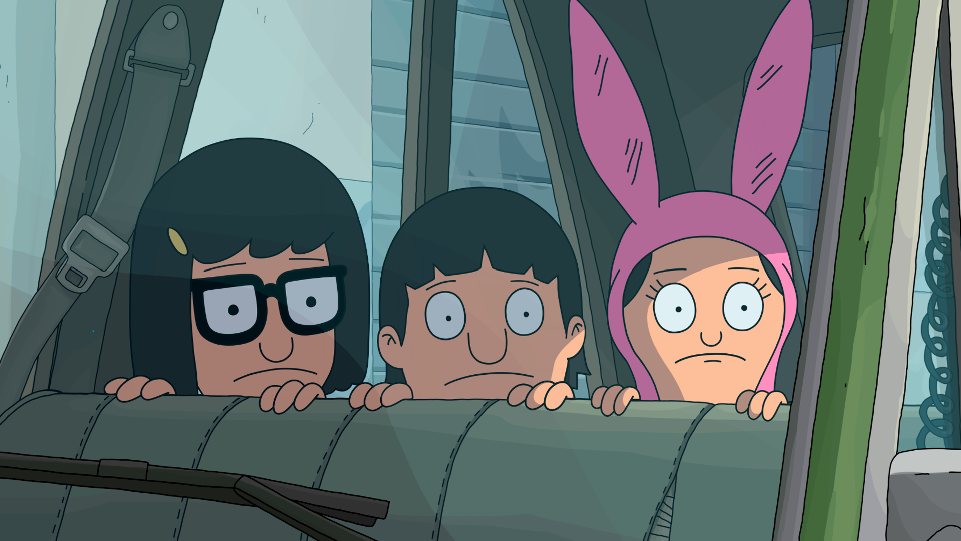 Tina, Gene, and Louise sit in the back of Sergeant Bosco’s police car peering from behind the backseat out the window beside them.